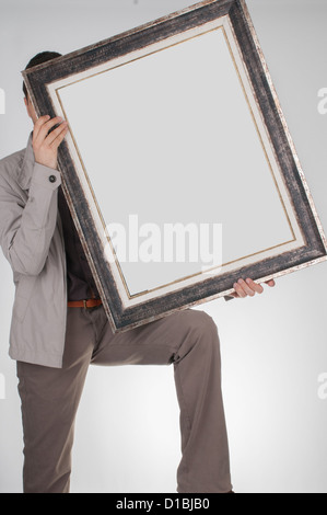 Man holding empty frame Stock Photo