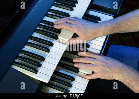 Playing a two manual electric keyboard Stock Photo