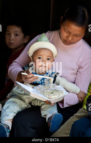 Mother Feeding Child, Xingping, Guangxi Province, China Stock Photo