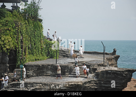 Prayers during Hindu ceremony at pilgrimage temple Pura Tanah Lot, Bali. Indonesia. Stock Photo