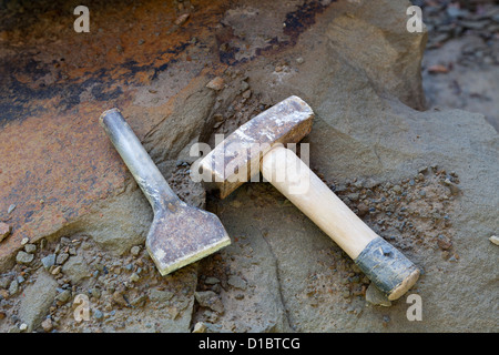 Stone masons tools, lump hammer and cold chisel on pennant sandstone Stock Photo