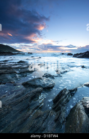 Twilight approaches over Polhawn Beach Whitsand Bay Cornwall UK Stock Photo