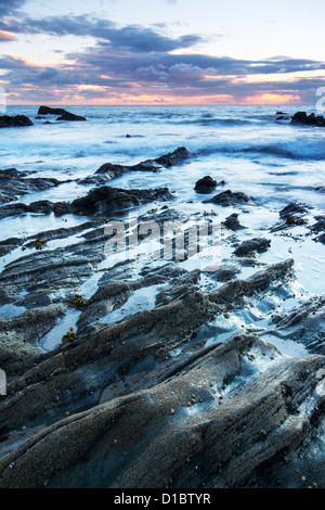 Twilight approaches over Polhawn Beach Whitsand Bay Cornwall UK Stock Photo