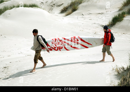 Amrum, Fog, Germany, two men with surfboard in the dunes before Kniepsand Stock Photo