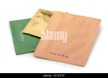 Three aluminum foil cosmetics sachets isolated on white Stock Photo