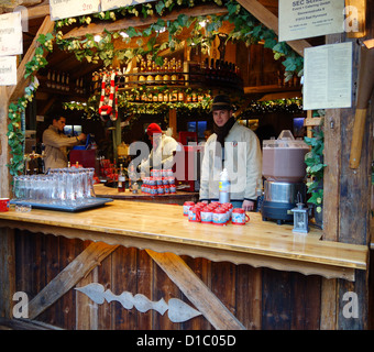 2 mugs of hot gluhwein / mulled wine in front of a christmas tree at ...