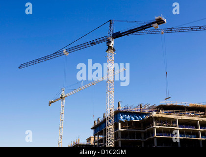 Tower cranes on construction site Stock Photo