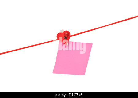 Pink sticky hanged on red rope isolated on white Stock Photo