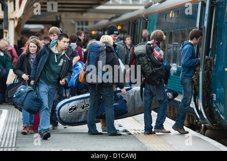 Aberystwyth, Wales, UK, December 15 2012:  Groups of young University and college students carrying bags of luggage catching the Arriva Wales train from Aberystwyth railway station at the end of term, going home to their families for the Christmas holiday vacation Stock Photo
