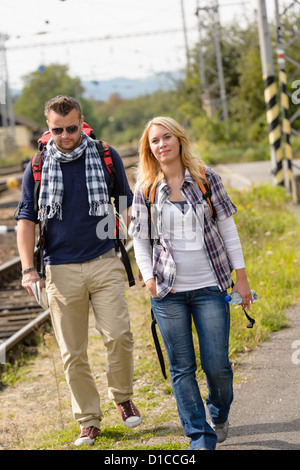 Couple walking with backpack in train station happy woman man Stock Photo