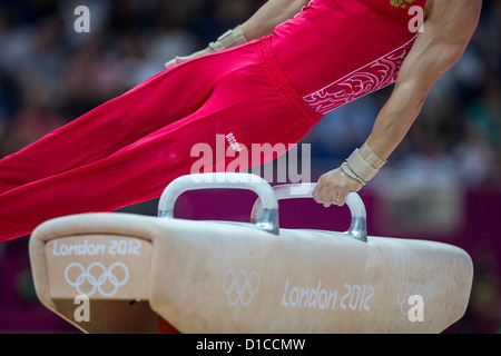 Detail of male gymnast's hands on the pommel horse during the Men's Gymnastics Individual All-Around at the 2012 Olympic Stock Photo