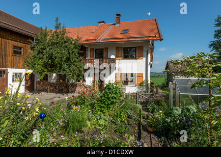 Traditional Upper Bavarian Farmhouse with cottage garden Stock Photo