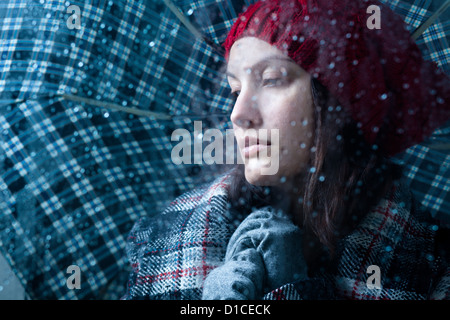 Sad Woman with Umbrella on a Rainy Day Stock Photo