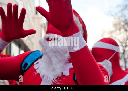 15 December 2012 London UK. Fancy dressed revellers roam central London during Santacon 2012. The annual celebration of all things Christmas which sees people dressed as Santa as well as elves, reindeer and Christmas trees has been running for twelve years. Stock Photo