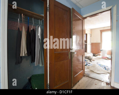 April 30, 2012 - Woonsocket, Rhode Island, United States - Light streams into an abondoned closet with only a few pieces of clothing left in a foreclosed house in Woonsocket, Rhode Island, United States (Credit Image: © David H. Wells/ZUMAPRESS.com) Stock Photo