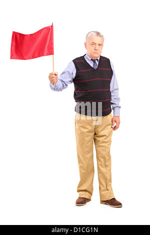 Full length portrait of a sad senior man waving a red flag isolated on white background Stock Photo