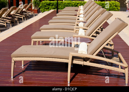 Empty lounge chairs in a row with towers Stock Photo