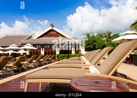 Resort lounge chairs at poolside. Stock Photo