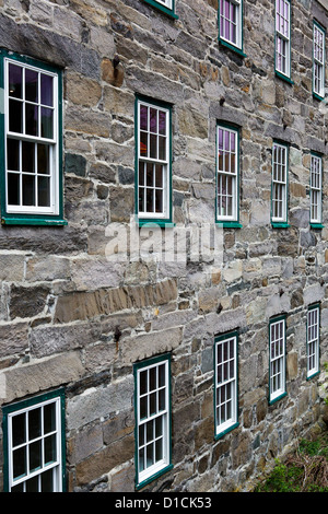 Two rows of windows on an old stone building Stock Photo