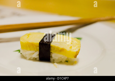 Tamago yaki is sushi using an egg on white plate Stock Photo