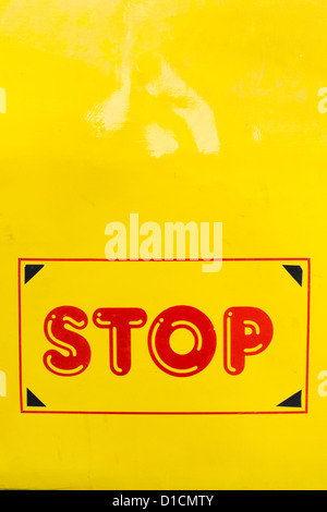 Red Stop sign painted on the side of a Yellow Indian school bus. Andhra Pradesh, India