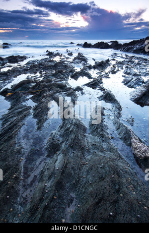 Twilight approaches over Polhawn Beach Whitsand Bay Cornwall UK Stock Photo