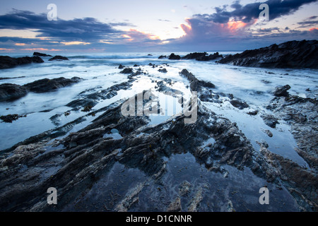 Twilight approaches over Polhawn Beach Whitsand Bay Cornwall UK Stock Photo