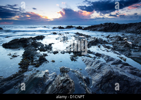 Twilight approaches over Polhawn Beach Whitsand Bay Cornwall UK Stock Photo