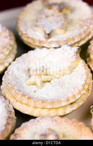 Christmas mince pies on a plate with hot chocolate drink, holly and ...