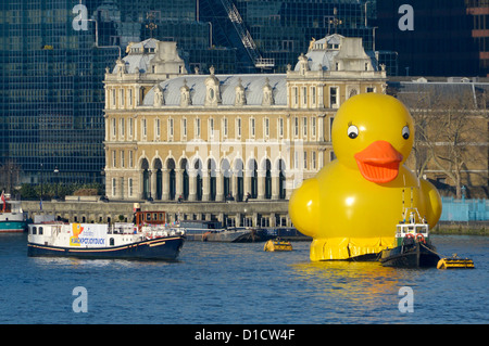 Yellow duck and tug boat moored in the Pool of London alongside a publicity barge promoting the Jackpotjoy bingo website