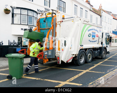 Man working at the rear of a waste disposal vehicle emptying wheelie bins for recycling in Pier Road Whitby Stock Photo