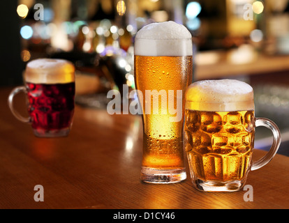Glass of light beer on a dark pub. Stock Photo