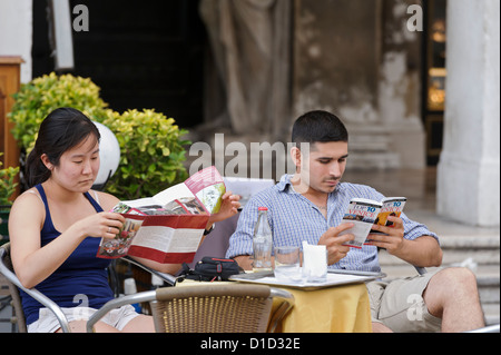 Tourists checking information about Venice, Italy. Stock Photo