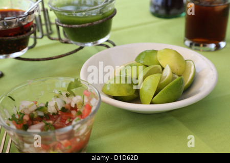 A bowl of limes and other condiments on a table in Punta de Mita, Nayarit, Mexico. Stock Photo