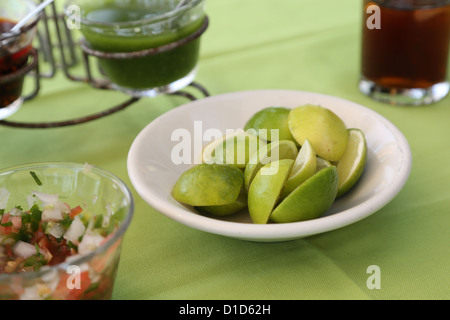 A bowl of limes and other condiments on a table in Punta de Mita, Nayarit, Mexico. Stock Photo