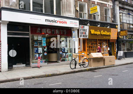 Shops selling musical instruments and offering lessons in Denmark Street in the West End of Central London. Stock Photo