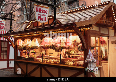 Traditional Christmas wooden market stall selling sweets, chocolate and candies at Potsdamer Platz, Berlin, Germany, Europe. Stock Photo