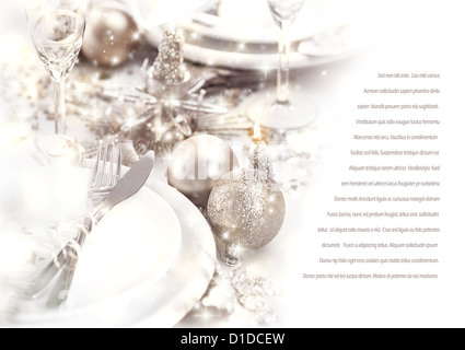Image of romantic holiday dinner, festive table setting decorated with beautiful silver bubbles and candles, luxury white plate Stock Photo