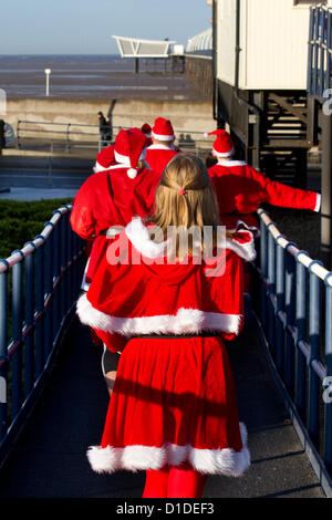 Southport, Merseyside, UK Sunday 16th December, 2012. Costumed runners and participants, seasonally dressed as Father Christmas, in the Queenscourt Hospice Christmas Santa Fun Run for Charity, a 1km route starting at Silcocks Leisure centre and following a route along the pier and round the Botanical Gardens Stock Photo