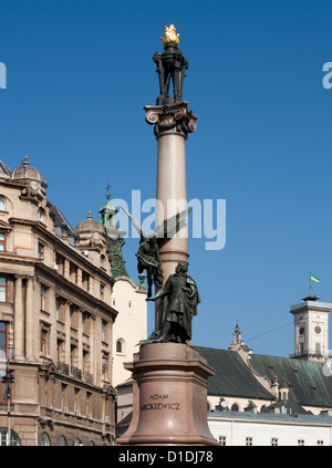 Adam Mickiewicz monument in Lviv, Ukraine. Town Hall with national flag on background. Stock Photo