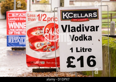 Signs outside a Spar shop, advertising 1 litre of Vladivar Vodka for £16 Stock Photo