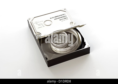 Half open hard drive and and a curly tape with files Stock Photo