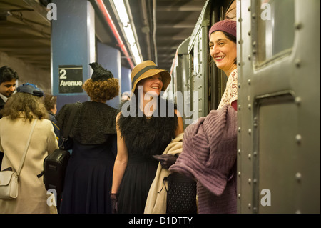 New Yorkers, tourists and subway buffs, some in period garb, travel on a vintage MTA Nostalgia Train Christmas season ride Stock Photo