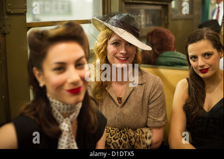 New Yorkers, tourists and subway buffs, some in period garb, travel on a vintage MTA Nostalgia Train Christmas season ride Stock Photo