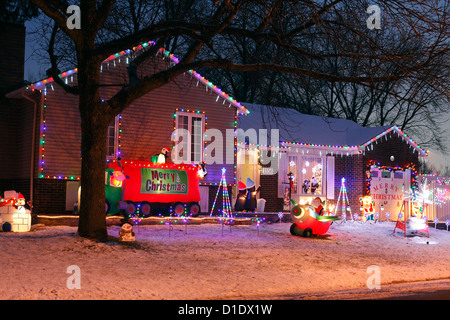 A Canadian House Lavishly Decorated With Christmas Lights On The Outside  And Garden At Night. Stock Photo