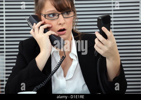 secretary overwhelmed by phone calls Stock Photo