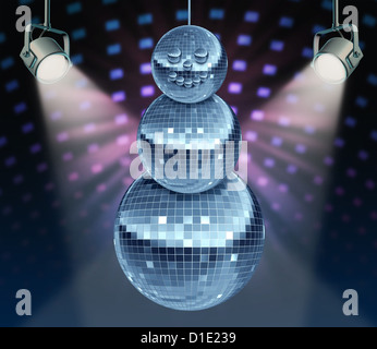 Winter holiday music symbol with Dance night disco balls as a mirror sphere in the shape of a snowman for festive fun and new year celebrations dancing party in a nightclub or dance club with glowing stage lights. Stock Photo