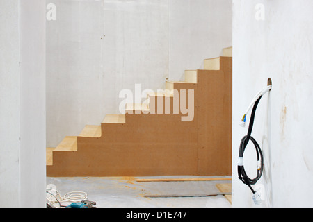 Construction in progress with graphic staircase forms and exposed cables Stock Photo