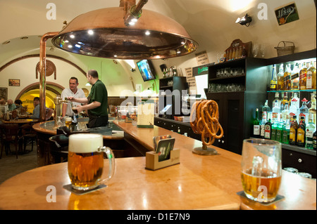 Barman pouring beer at bar of U Vejvodu Pub, Old Town, Prague, Czech Republic, Europe Stock Photo