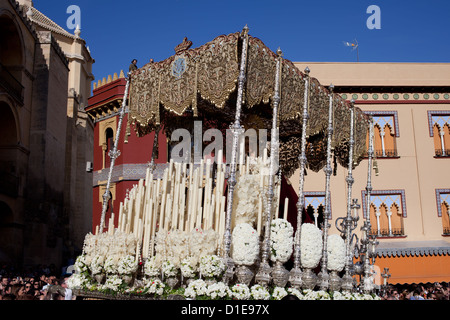 Virgin Mary on a gilded platform in procession of the Semana Santa (Holy Week) in the Old Town of Cordoba, Spain. Stock Photo